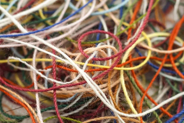 Multi-colored tangled colorful needlecraft silk thread rope. Mac — Stock Photo, Image
