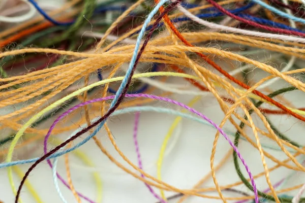 Multi-colored tangled colorful needlecraft silk thread rope. Mac — Stock Photo, Image