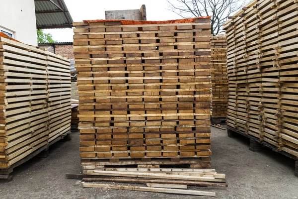 Stack of new wooden boards and studs at the lumber yard. Wooden