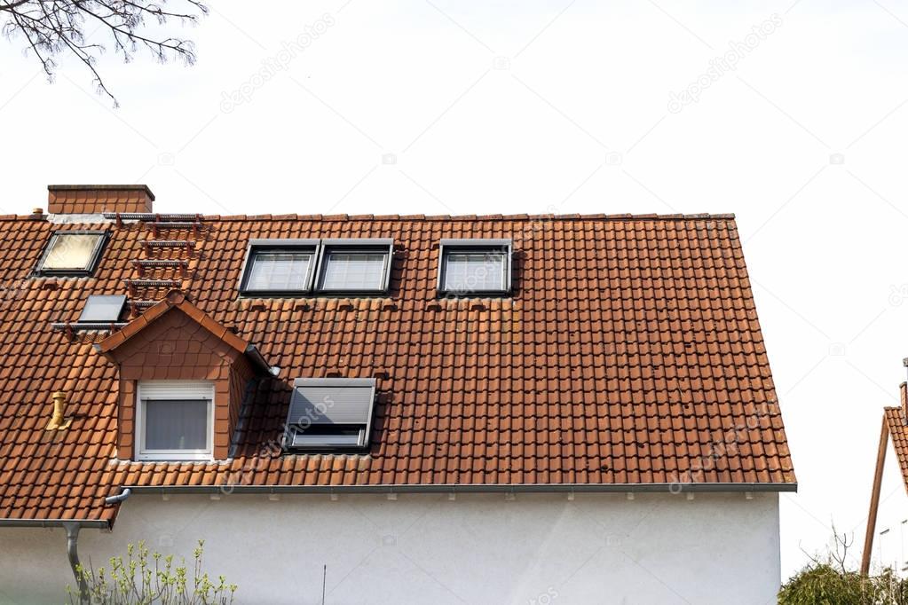 Roof of classic residential houses with orange roofing tiles and