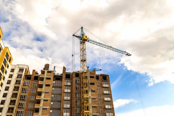 Vinç ve yüksek doğmak inşaat mavi gökyüzü altında bina