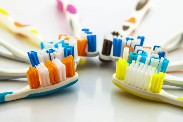 Close up shot of set of multicolored toothbrushes on clean toile — Stock Photo, Image