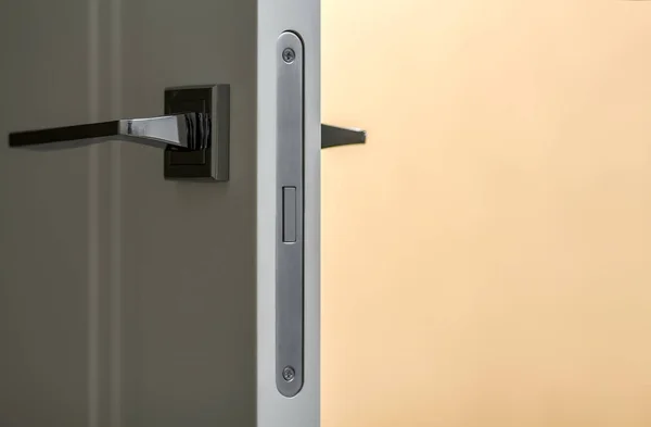 Modern metal handle on white door close-up interior detail — Stock Photo, Image