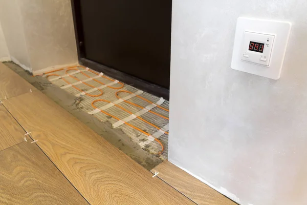 Installation of heating elements in warm tile floor and control