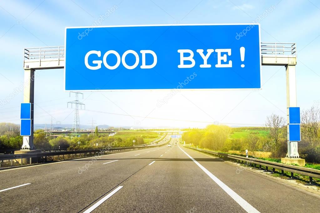 Blue freeway sign over the road on sunny day with words Good Bye