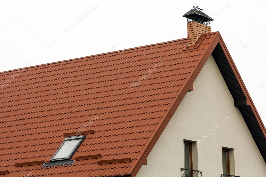 Roof of a new house made from yellow roofing tiles