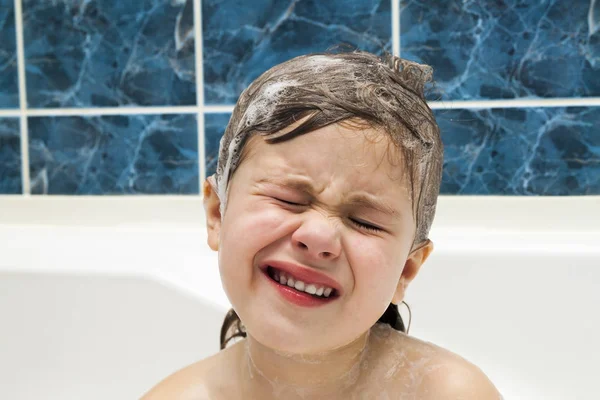 Маленькая девочка в ванной, моет голову. Символ чистоты — стоковое фото