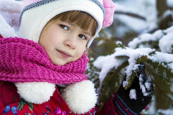 Portrait of pretty little girl in winter clothes near snow cover — Stock Photo, Image
