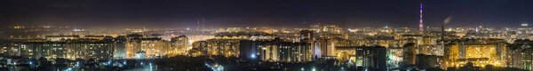 Panorama of night aerial view of Ivano-Frankivsk city, Ukraine with bright lights and high buildings.