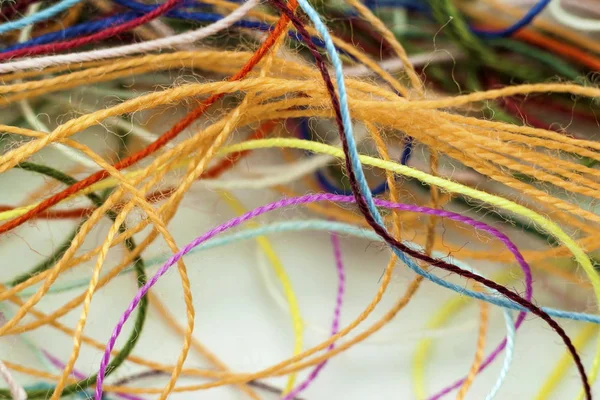 Multi-colored tangled colorful needlecraft silk thread rope. Mac — Stock Photo, Image