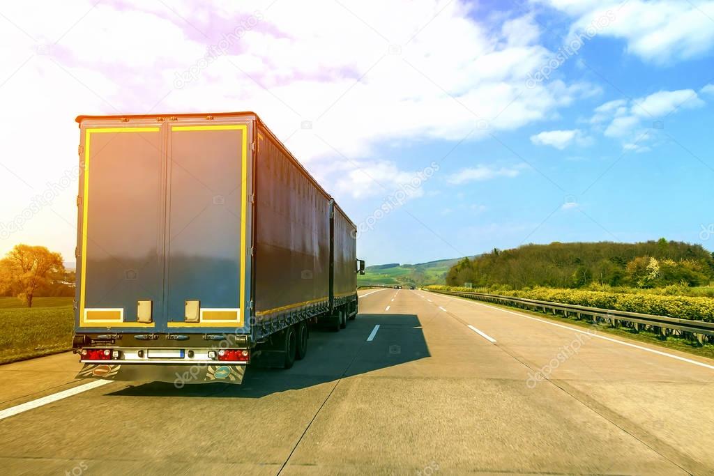 Blue cargo truck on an empty freeway