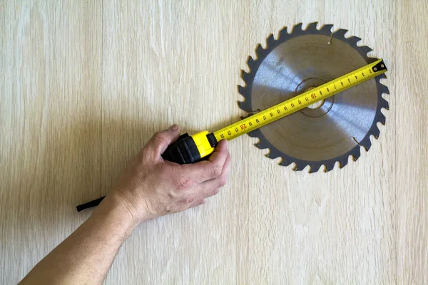 Primer plano de la hoja de sierra circular para el trabajo de madera y el ingenio de la mano del trabajador — Foto de Stock