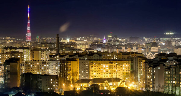 Panorama of night aerial view of Ivano-Frankivsk city, Ukraine with bright lights and high buildings.