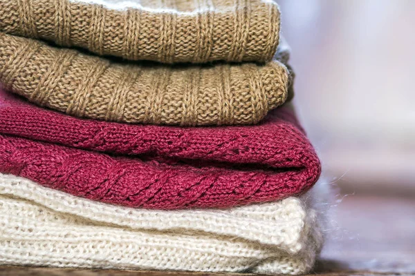 Stack of warm woolen cozy knitted sweaters — Stock Photo, Image