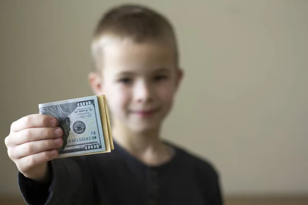 Cheerful blurred boy showing american dollars money. — Stock Photo, Image