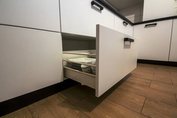 Відкрита кухонна шухляда з тарілками всередині, розумне рішення для зберігання та організації кухні — стокове фото