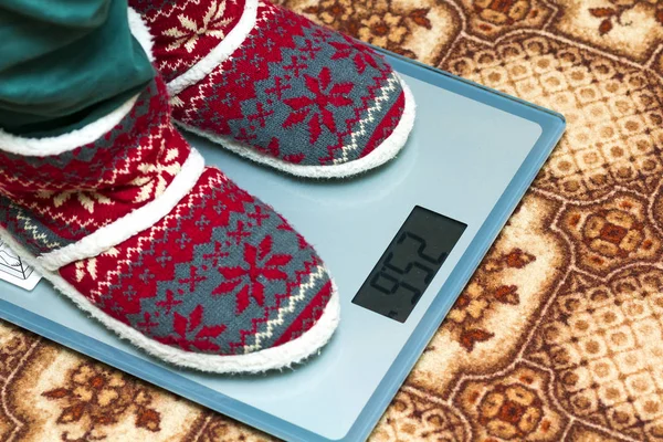 Person feet in new year shoes standing on weight scales