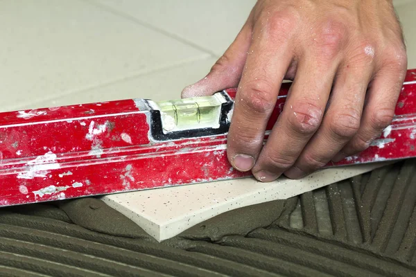 Azulejos e ferramentas para tigre. Trabalhador mão instalar chão — Fotografia de Stock