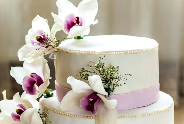 Beautiful wedding cake with flowers, close up of cake with blurr