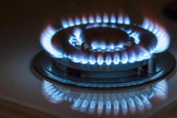 Closeup shot of blue fire from domestic kitchen stove. Gas cooke — Stock Photo, Image
