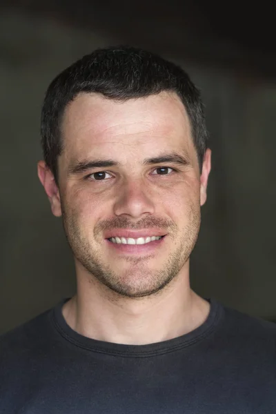 Portrait of young handsome black-haired unshaven confident succe