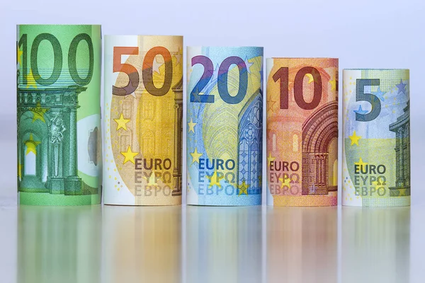 Straight row of accurately rolled hundred, fifty, twenty, ten and five new paper euro banknotes isolated on white background. Symbol of financial prosperity, wealth, success, savings and business. — Stock Photo, Image