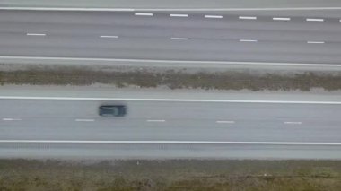 Hızlı hareket eden trafik arabaları olan bir yolun havadan aşağı görüntüsü.