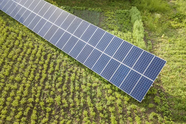 Blue solar panels for clean energy on green grass. — Stock Photo, Image