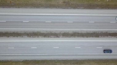 Hızlı hareket eden trafik arabaları olan bir yolun havadan aşağı görüntüsü.