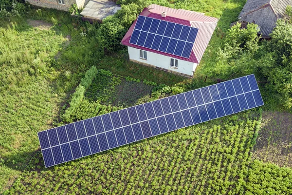 Flygvy över ett hus med blå solpaneler för ren energi. — Stockfoto