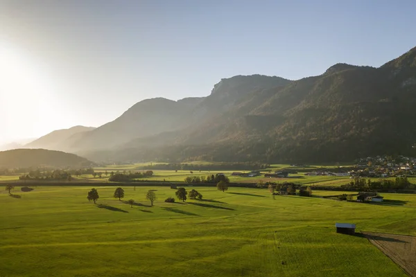 Aerial view of green meadows with villages and forest in austria — Stock Photo, Image