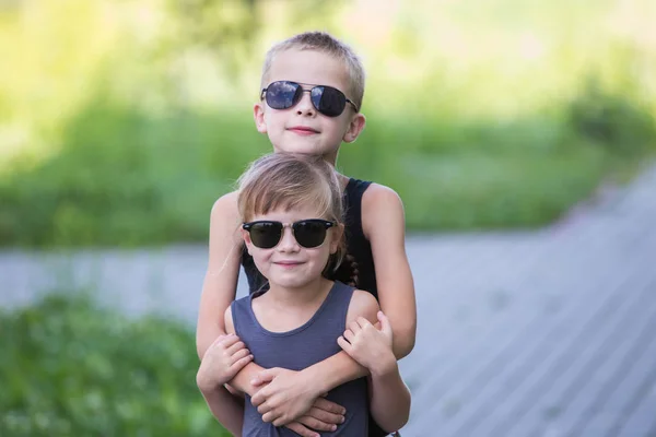 Zwei Kinder mit schwarzer Sonnenbrille haben Spaß im Freien in Summe — Stockfoto