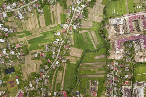 Top down aerial view of town or village with rows of buildings a — Stock Photo, Image