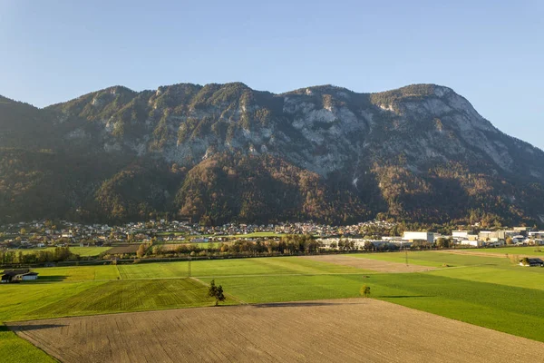 Aerial view of green meadows with villages and forest in austria — Stock Photo, Image