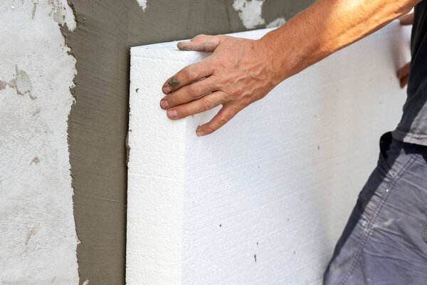 Insulation of facade wall with styrofoam sheets. Polystyrene ins