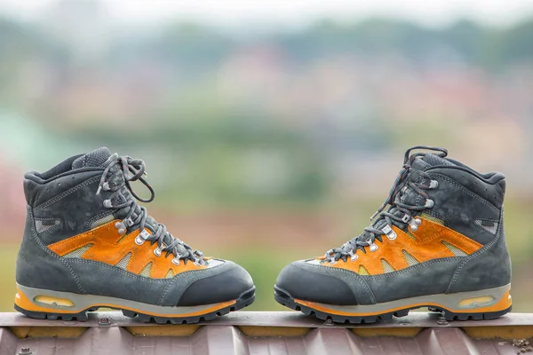 A pair of leather trekking hiking winter boots on blurred backgr — Stock Photo, Image