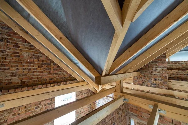 Espacio ático de un edificio en construcción con vigas de madera o —  Fotos de Stock