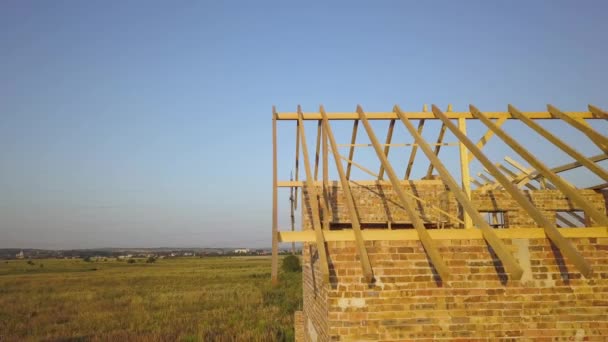 Aerial view of unfinished brick house with wooden roof structure under construction. — Stock Footage Aerial View Unfinished Brick House Wooden Roof Structure Construction Stock Video