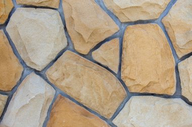 Kum taşlarından yapılmış soyut duvar yüzeyi gergedan olarak kullanılacak.