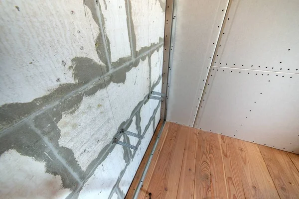 Unfinished brick wall in a room under construction prepared for