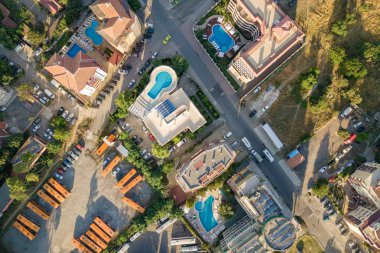 Otellerin çatıları, park halindeki arabaların olduğu caddelerin yukarıdan görünüşü.