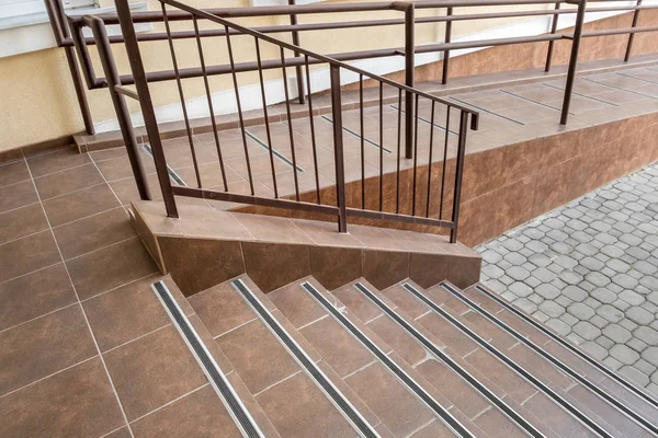 Concrete entrance stairs covered with ceramic tiles with metal r — Stock Photo, Image