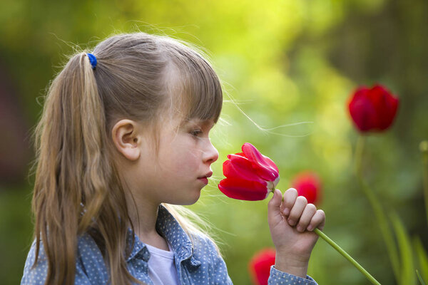 Profile of cute pretty smiling child girl with gray eyes and lon