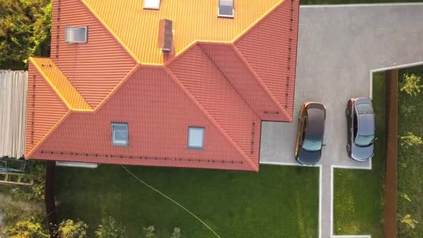 Top down aerial view of a private house with red tiled roof and spacious yard with parked two new cars. — Stock Footage Top Aerial View Private House Red Tiled Roof Spacious Yard Stock Footage