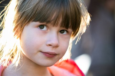 Portrait of a pretty child girl outdoors on a sunny warm autumn 