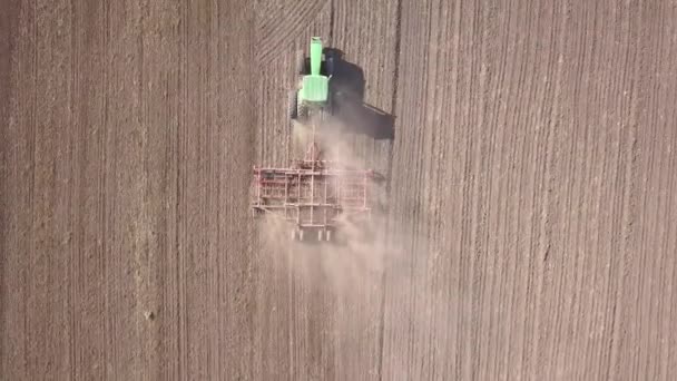 Top Aerial View Green Tractor Cultivating Ground Seeding Dry Field — Stock Video