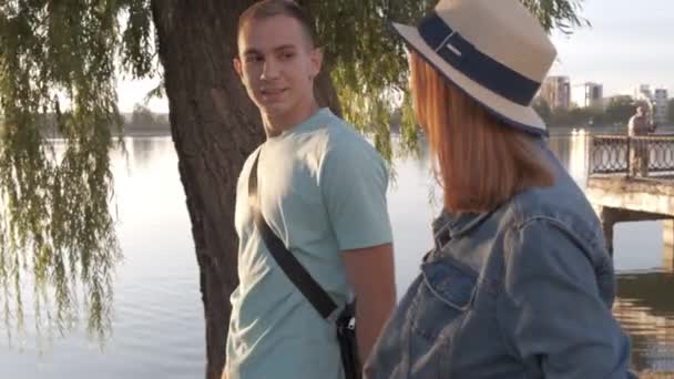 Happy Teenage Couple Walking Autumn Park Lake Shore Chatting Happily — Stock Video