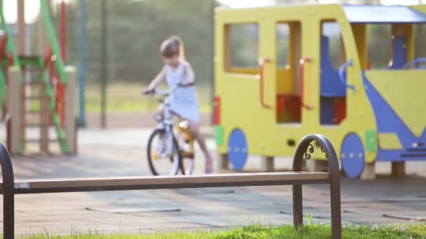 Cute Little Girl Sitting Bench Riding Bicycle School Yard Summer — Stock Video