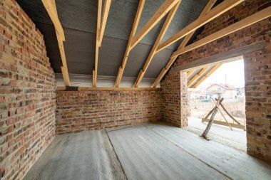 Interior of unfinished brick house with concrete floor, bare wal clipart