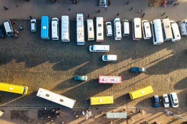 Aerial view of many cars and buses moving on a busy city street. clipart